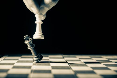 White queen knocks king chessboard.